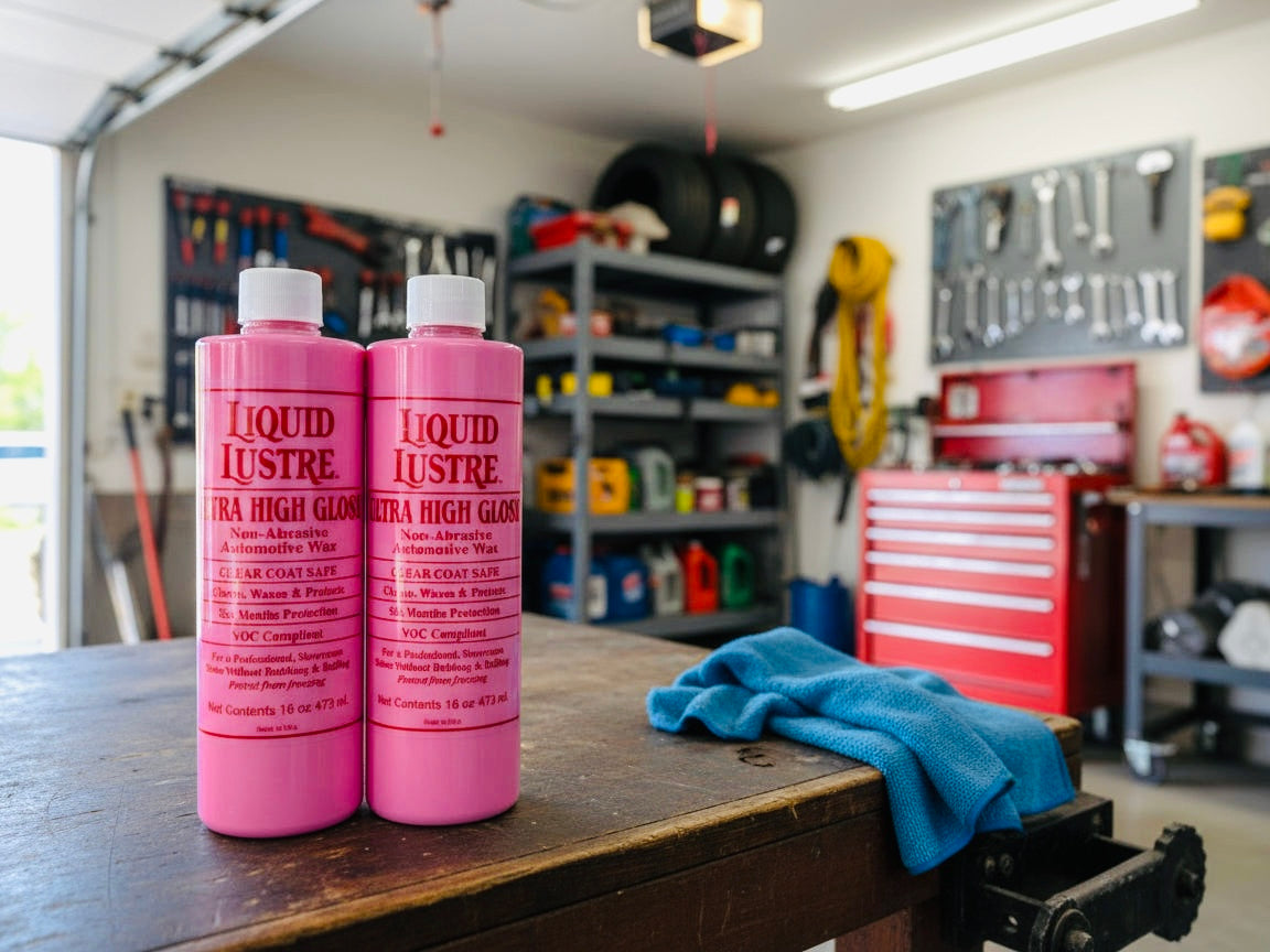 Two bottles of Liquid Lustre Original Pink Wax on a workbench in a garage setting.