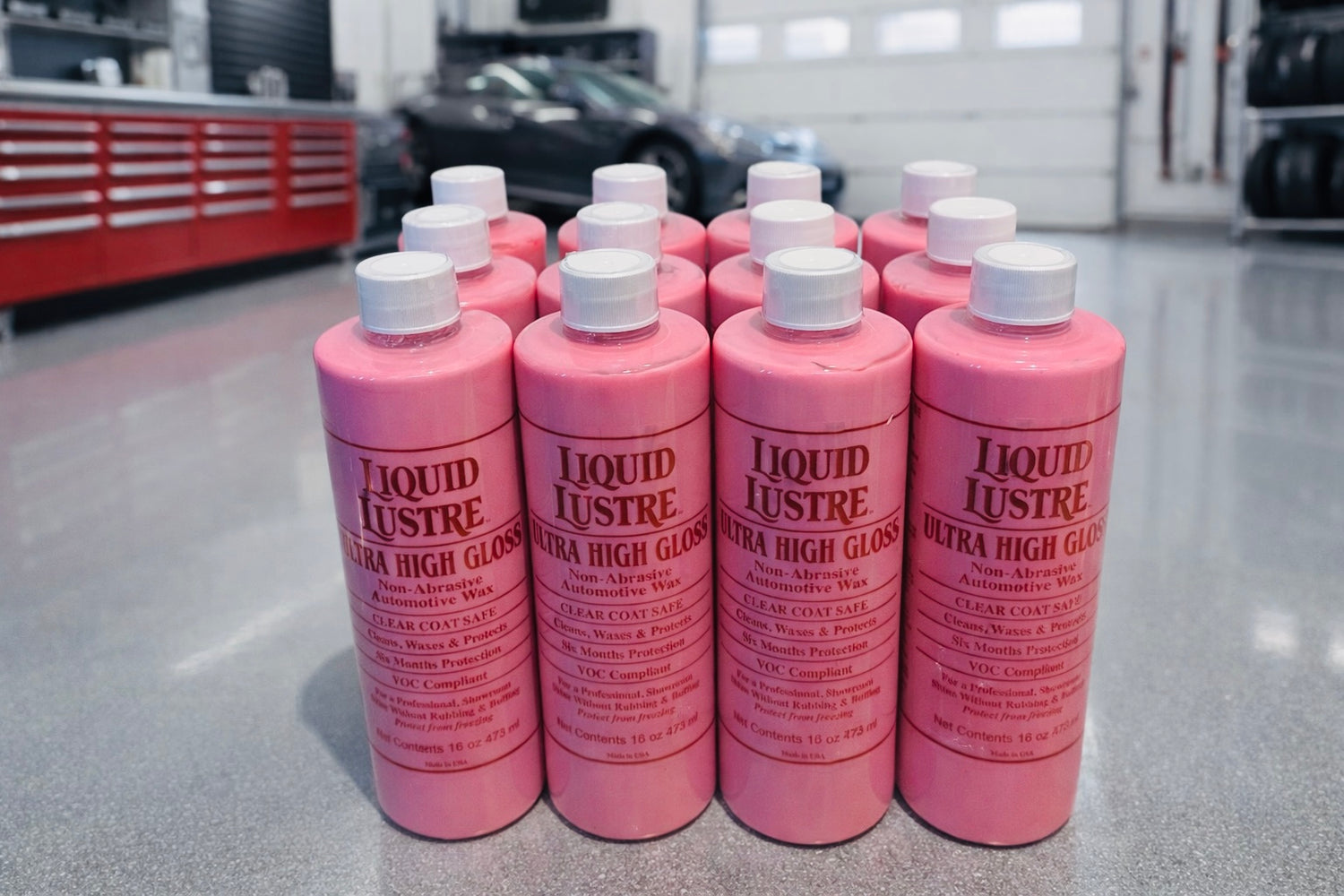 One Case of Liquid Lustre Original Pink Wax in a garage on the floor 